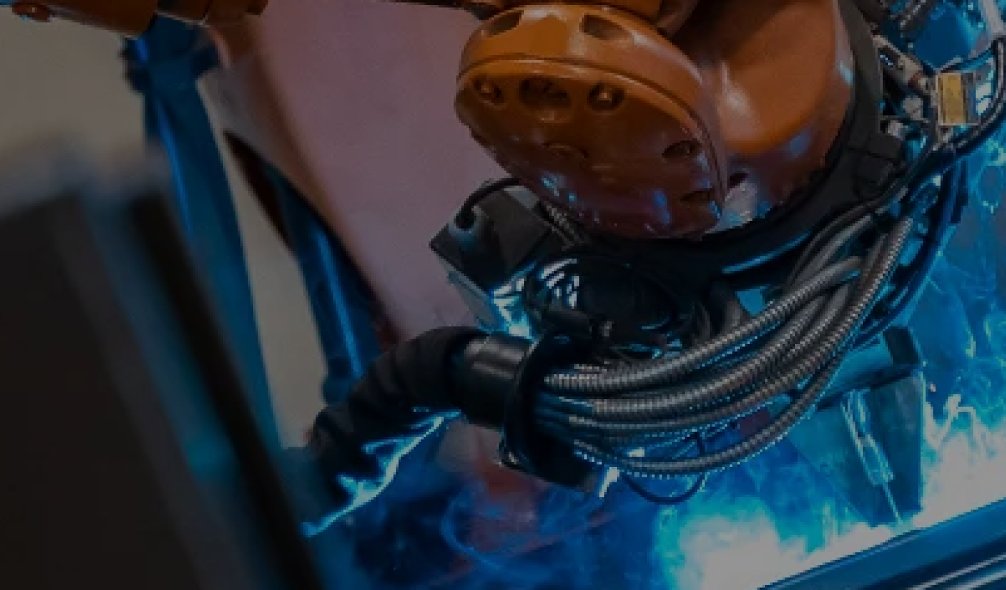 A robot is welding on a machine.