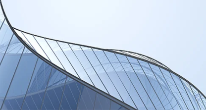 A blue building with a curved glass facade.