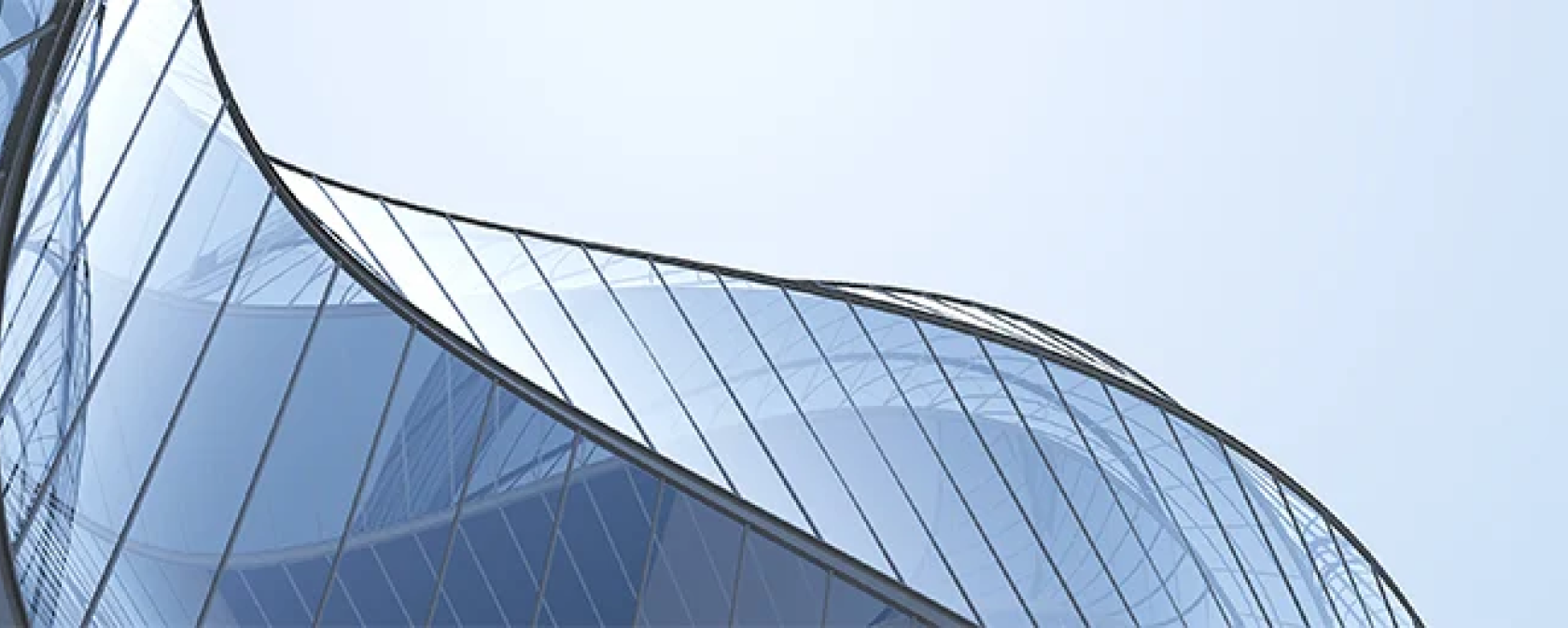 一栋蓝色建筑，外墙采用弧形玻璃幕墙。