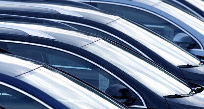 Rows of parked cars are lined up closely together in a parking lot, viewed from the side—just outside a corporate law office, where lawyers in Chicago handle complex legal matters daily.