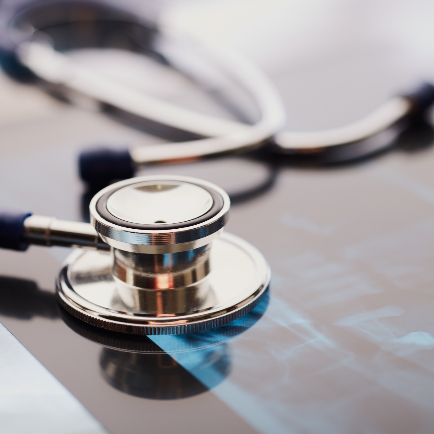 A stethoscope resting on top of an X-ray image in a corporate law office, representing collaboration between medical professionals and lawyers in Chicago.