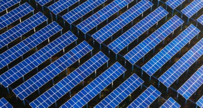 Rows of blue solar panels arranged in a grid pattern outdoors, viewed from above, with the Foley & Lardner LLP logo in the bottom right corner, representing innovation at this leading corporate law office.
