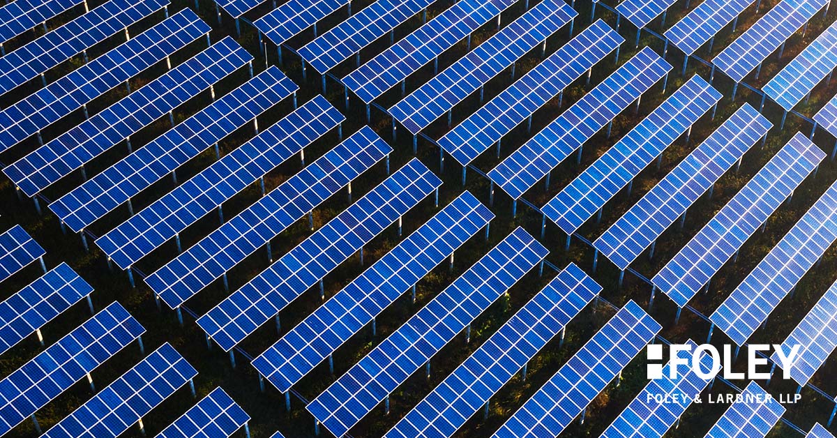 Rows of blue solar panels arranged in a grid pattern outdoors, viewed from above, with the Foley & Lardner LLP logo in the bottom right corner, representing innovation at this leading corporate law office.