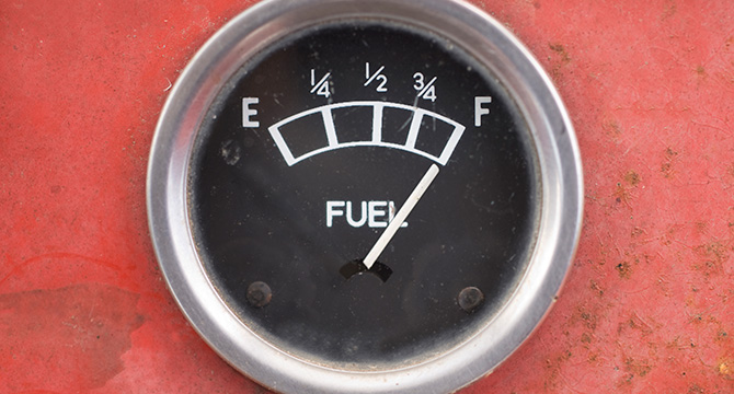Close-up of a fuel gauge on a red background, with the needle pointing to full—a fitting image for litigation support provided by top law offices.