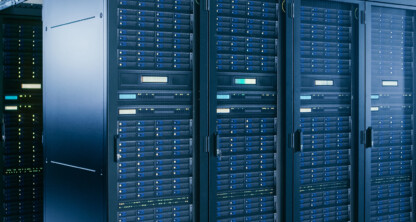 Rows of black server racks with blue indicator lights in a modern data center, supporting the secure digital infrastructure relied upon by today’s leading law offices and corporate law firms.