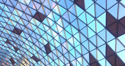 Geometric glass ceiling with triangular and diamond-shaped patterns, allowing natural light to enter the law offices below—an inspiring setting for Chicago lawyers and litigation support teams.