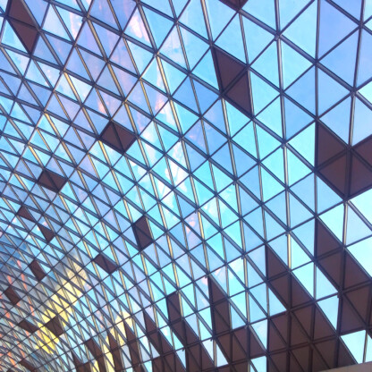 Geometric glass ceiling with triangular and diamond-shaped patterns, allowing natural light to enter the law offices below—an inspiring setting for Chicago lawyers and litigation support teams.