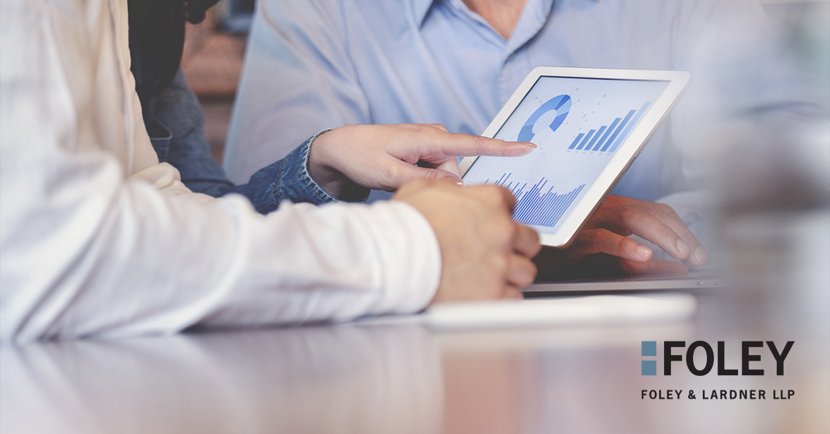 Two people review financial charts and graphs on a tablet at a table, highlighting expertise found in leading law offices. The Foley & Lardner LLP logo is visible in the lower right corner.