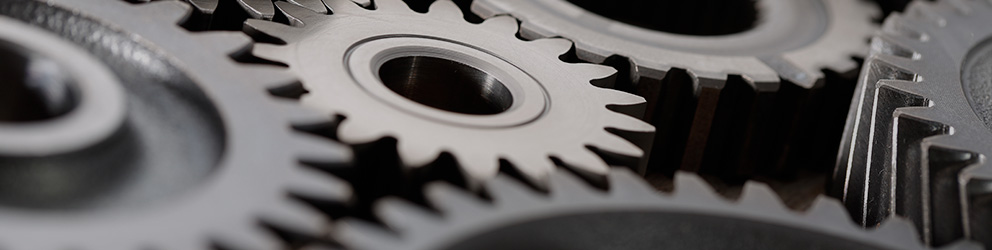 Close-up of several interlocking metal gears with sharp teeth, showing mechanical detail and precision engineering, reflecting the meticulous work and collaboration found in leading law offices and among top lawyers in Chicago.