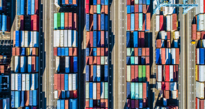 Aerial view of a shipping container yard with rows of colorful containers and large cranes, illustrating the complex logistics that often require litigation support from experienced lawyers in Chicago.