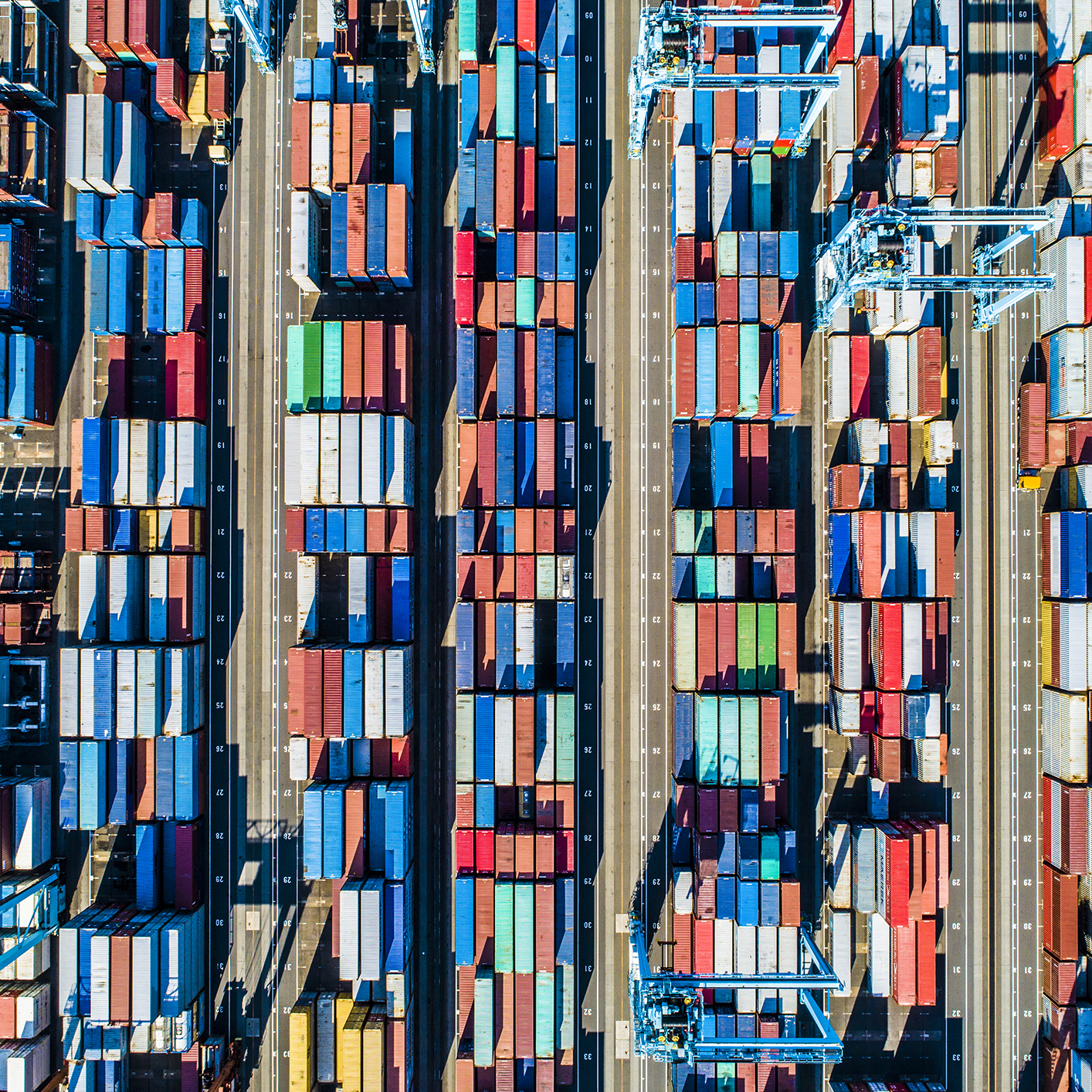 Aerial view of a shipping container yard with rows of colorful containers and large cranes, illustrating the complex logistics that often require litigation support from experienced lawyers in Chicago.