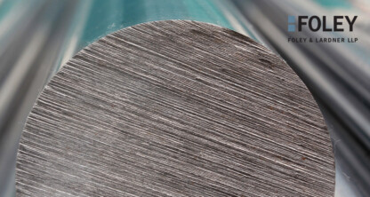 Close-up of the cross-section of a metal rod with visible surface texture; Foley & Lardner LLP logo appears in the top right corner, highlighting their expertise in intellectual property law.