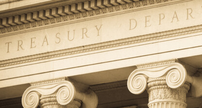 Close-up view of stone columns and entablature with "TREASURY DEPART" inscribed, part of a classical-style government building facade—an iconic setting often associated with lawyers in Chicago and prestigious corporate law offices.