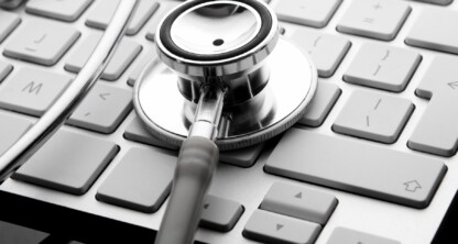 A stethoscope rests on a computer keyboard, symbolizing the intersection of healthcare, technology, and intellectual property law.