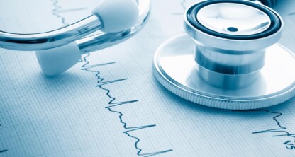 A stethoscope rests on a printed electrocardiogram (ECG) graph displaying heart rhythm patterns, capturing a scene reminiscent of precision often found in a corporate law office.