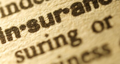 Close-up of the word "insurance" in bold text on a printed dictionary page, often referenced by law offices and chicago lawyers when assisting clients with legal matters.