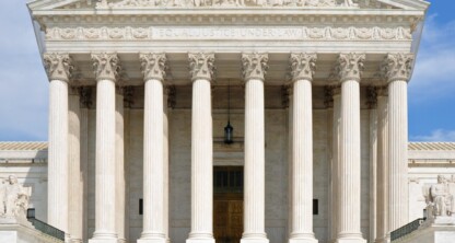Front view of the United States Supreme Court building featuring tall columns, a wide staircase, and the inscription "EQUAL JUSTICE UNDER LAW" above the entrance—an iconic site for litigation support and landmark intellectual property law decisions.