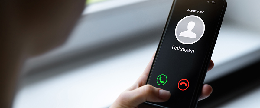 A person holds a smartphone displaying an incoming call from an unknown caller, with green accept and red decline buttons visible on the screen—perhaps it's one of the top lawyers in Chicago reaching out.