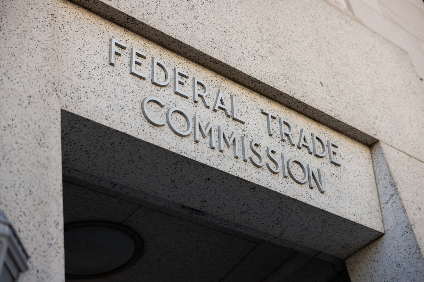 Stone building entrance with the words "Federal Trade Commission" engraved above the doorway.