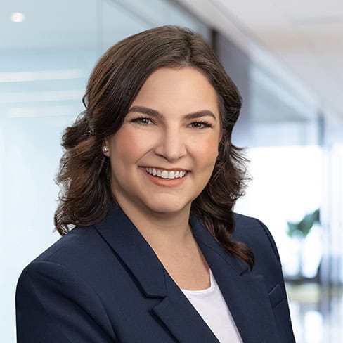 Experienced legal professional smiling in modern office setting at Foley & Lardner LLP.