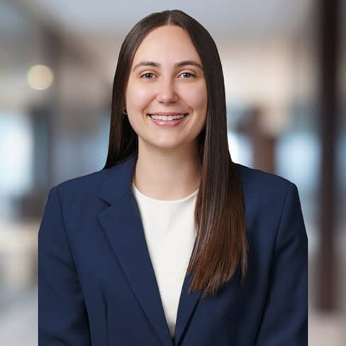 Professional woman in business suit smiling for Foley & Lardner LLP.